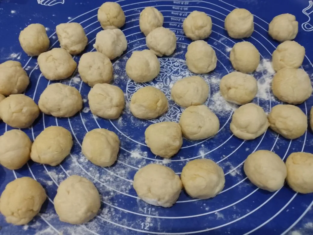 Песочное и рассыпчатое печенье, с начинкой из творога и изюма: Тесто достаем их холодильника и разделяем на небольшие колобки.