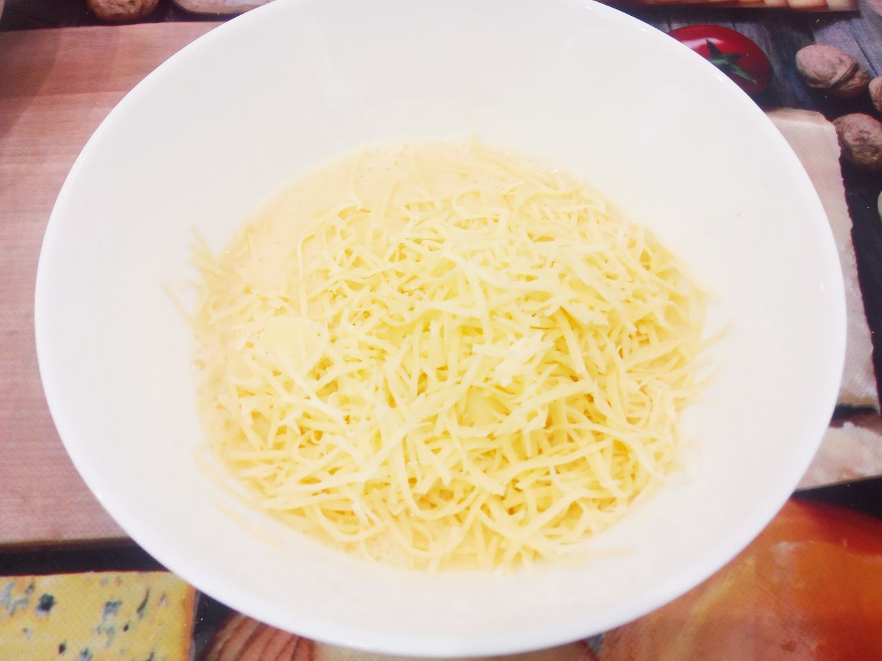 Отбивные  из свинины в кляре из яиц и сыра, вкусные и сытные: Твердый сыр натираем на терке, выкладываем в яичную смесь, солим по вкусу и хорошо кляр перемешиваем.