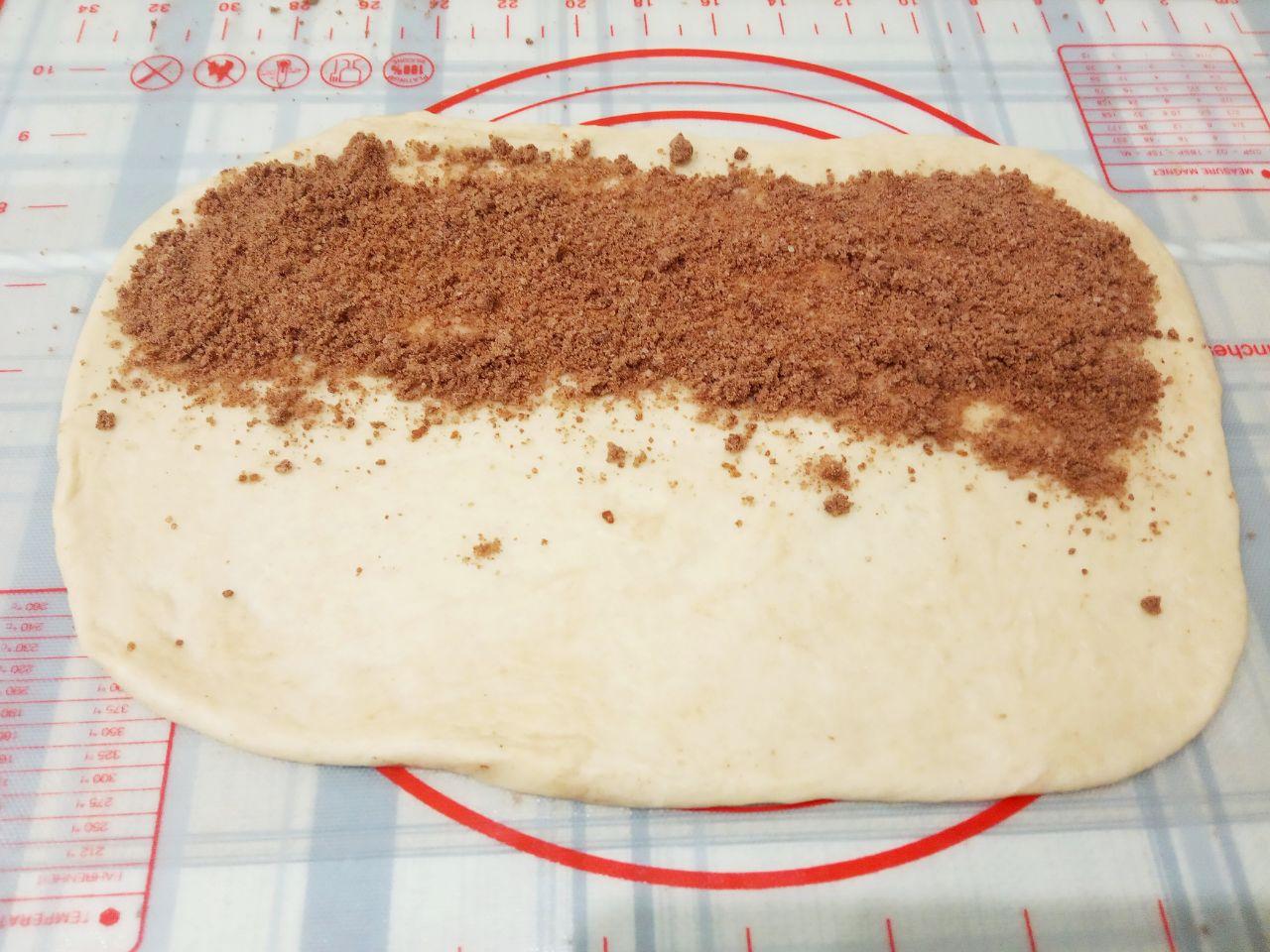 Домашние булочки с начинкой из шоколадной крошки: На половину прямоугольника распределяем часть крошки и второй половиной накрываем крошку, раскатываем скалкой.