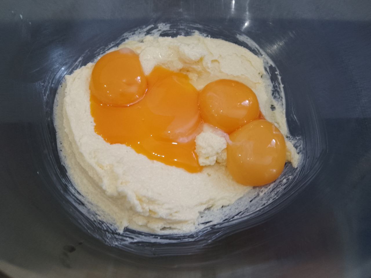 Печенье из рисовой муки в кокосовой стружке и кунжуте: Добавляем яйцо и три желтка, ванильный сахар, размешиваем.