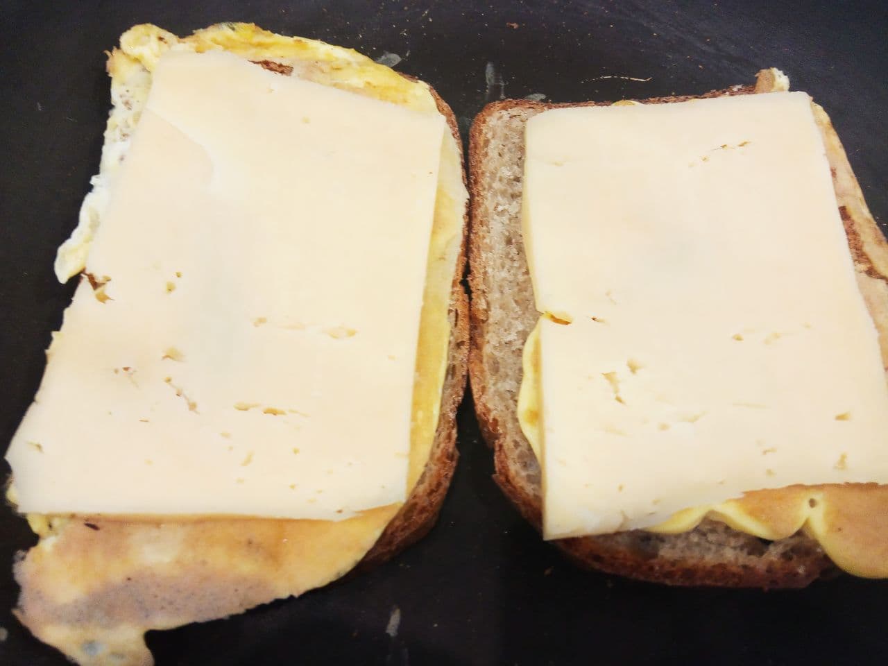 Горячие бутерброды на завтрак, не только быстро, но и вкусно: Осторожно переворачиваем ломтики бутерброда и кладем ломтики сыра.