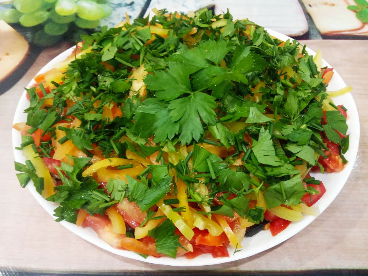 Салат из баклажанов, с помидорами и сыром: Посыпаем измельченной зеленью и заправляем растительным маслом.