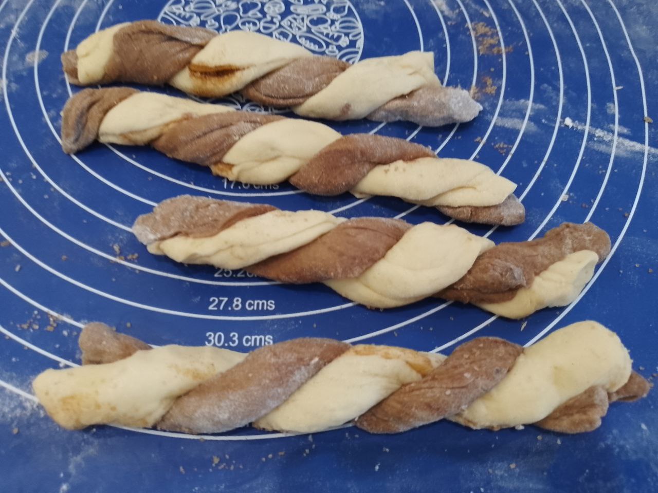 Воздушные булочки из дрожжевого теста с вареньем и корицей: Полоски из белого и темного теста сплетаем косичкой.