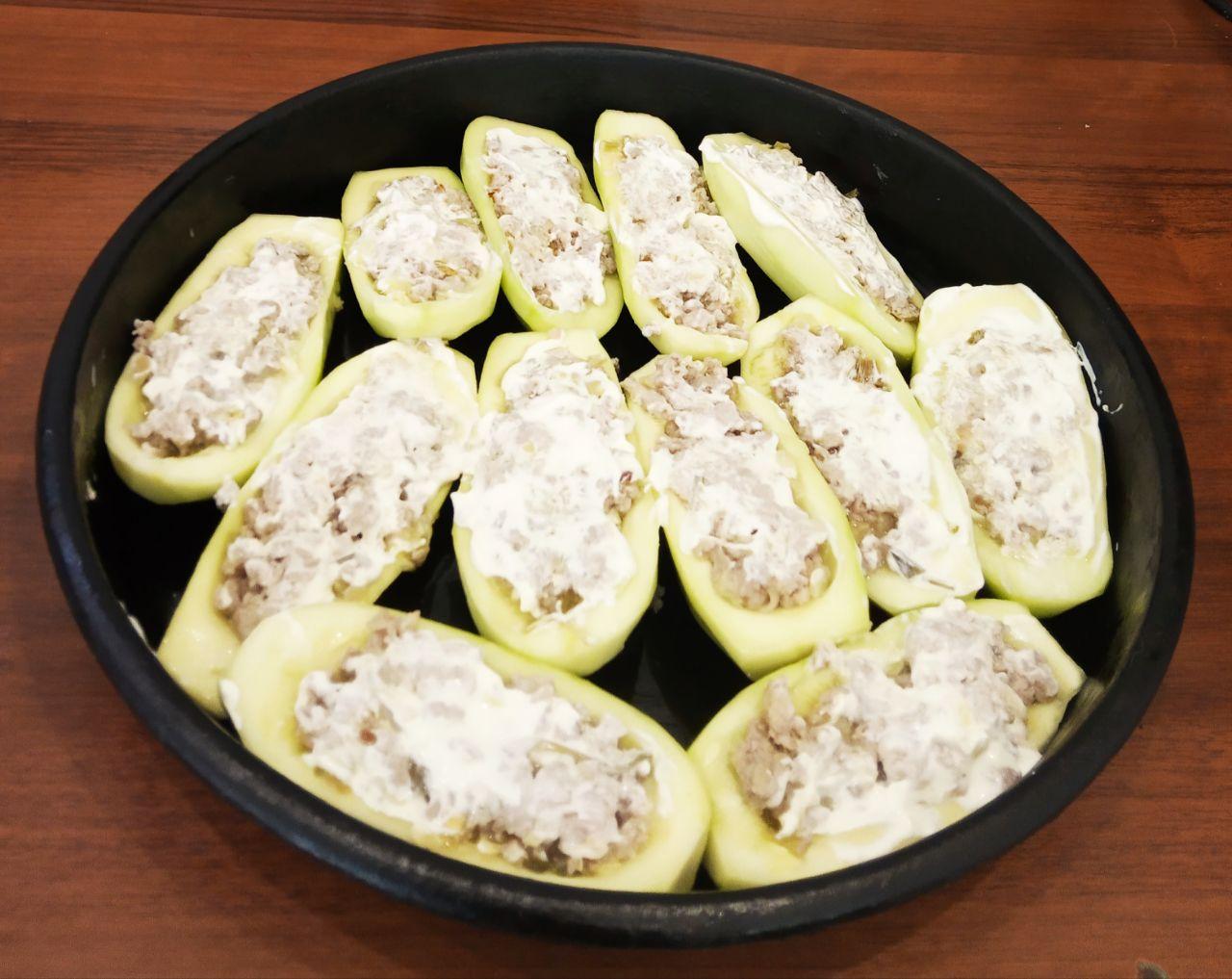 Кабачки фаршированные мясной начинкой и сыром: Противень смазываем жиром и укладываем нафаршированные половинки кабачков, сверху смазываем майонезом.