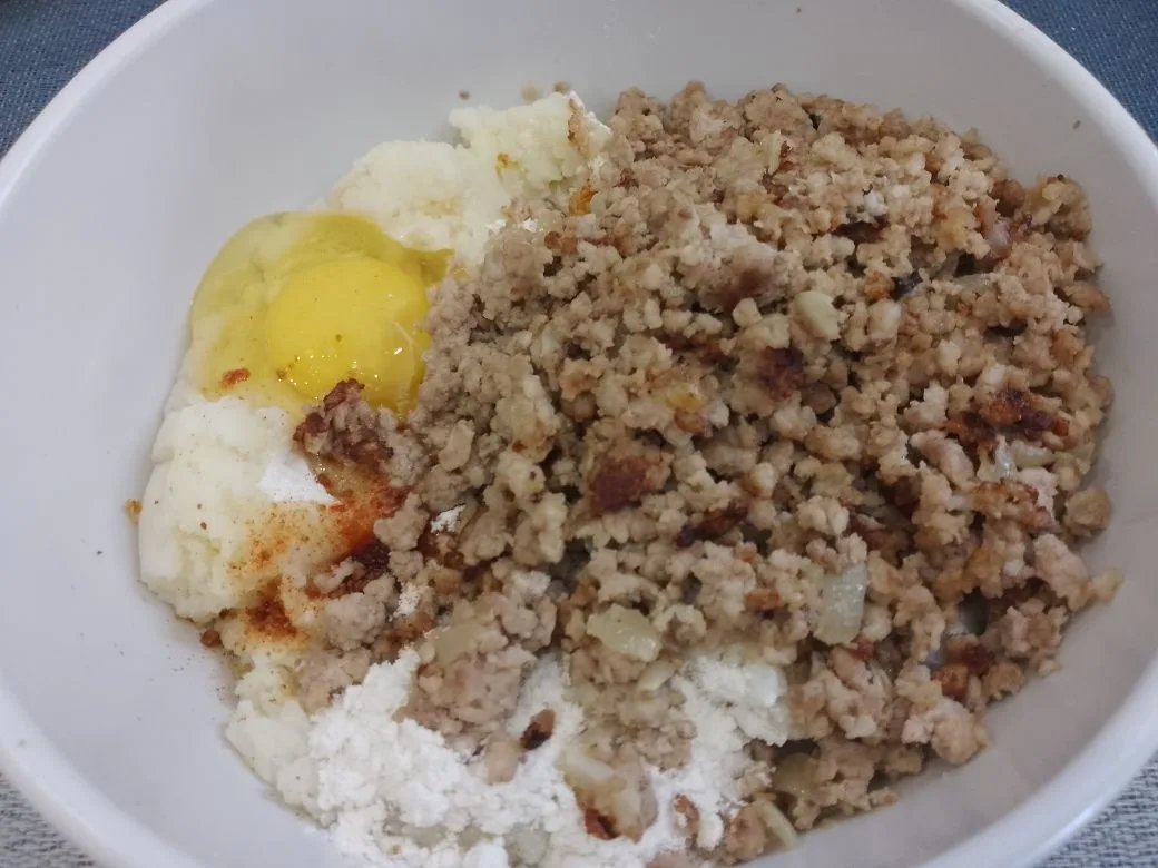 Котлеты из картофельного пюре и фарша, в яичном кляре: Соединяем пюре, обжаренный фарш, яйцо, муку, перец молотый и чеснок молотый по вкусу.