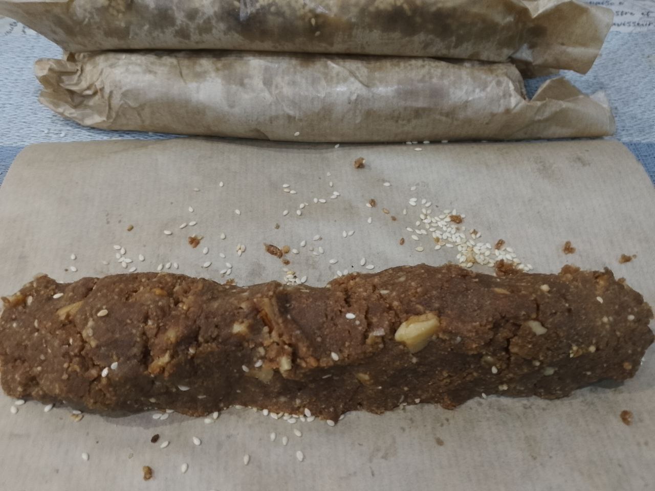 Десерт из печенья, сгущенного молока и орехов: Формируем длинную колбаску и плотно заворачиваем пергаментом.