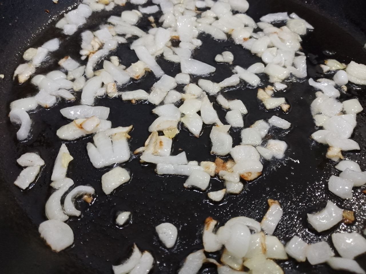 Баклажаны с начинкой из мяса и овощей, в духовке: Разогреваем сковороду с растительным маслом и обжариваем лук до золотистого цвета.