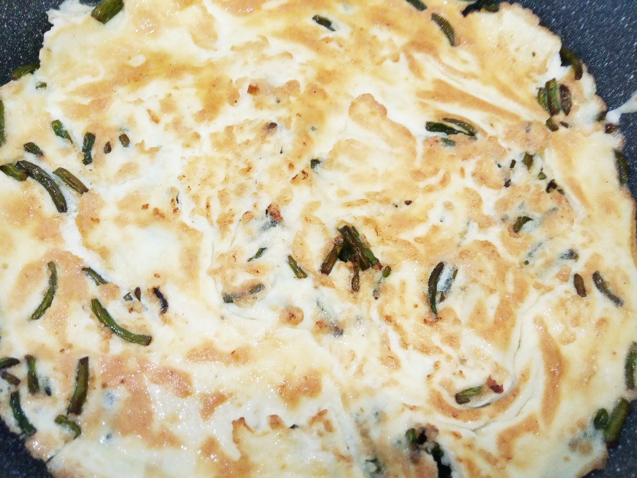 Вкусный и аппетитный завтрак из омлета, чесночных стрелок и сыра: Затем переворачиваем омлет на другую сторону.