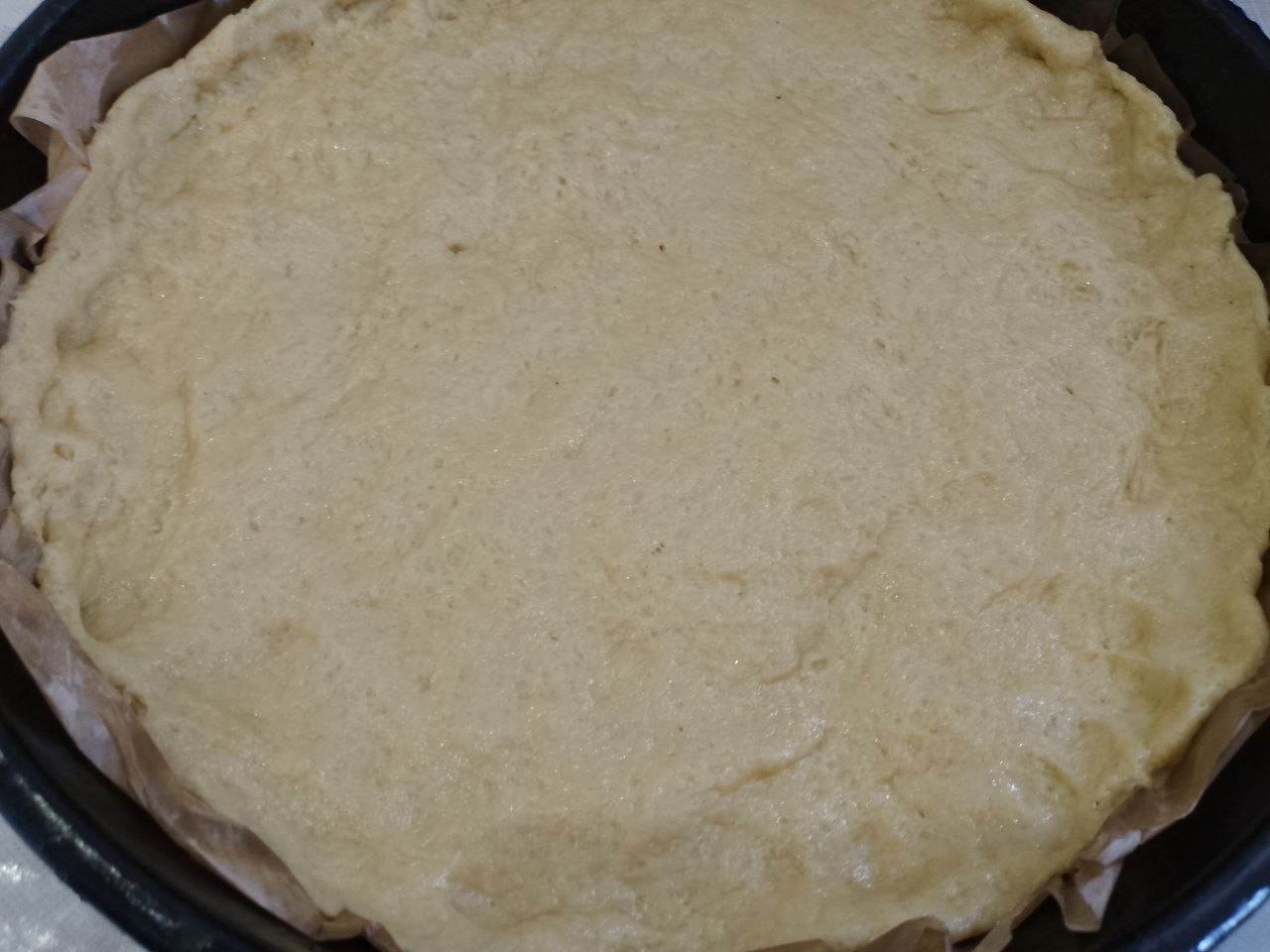Пирог из песочного теста и клубничной начинки с штрейзельной крошкой: Форму для пирога застилаем пергаментом. Тесто равномерно распределяем по форме, формируем бортики по краям.