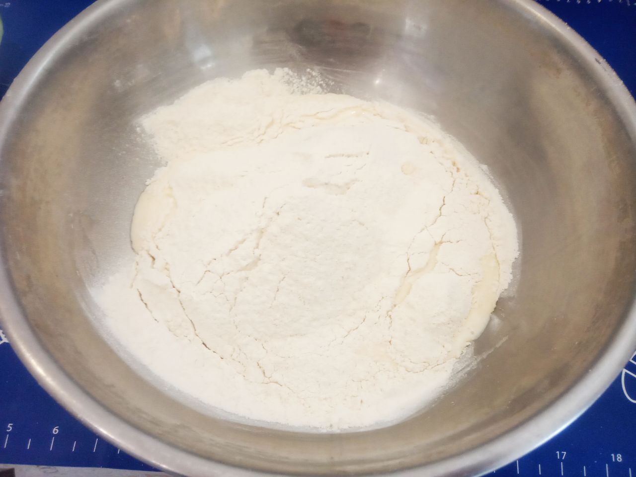 Жареные пирожки из творожного теста, с фаршем и луком, вкусные и аппетитные: Муку просеиваем через сито и добавляем частями в тесто. Замешиваем мягкое и нежное тесто.