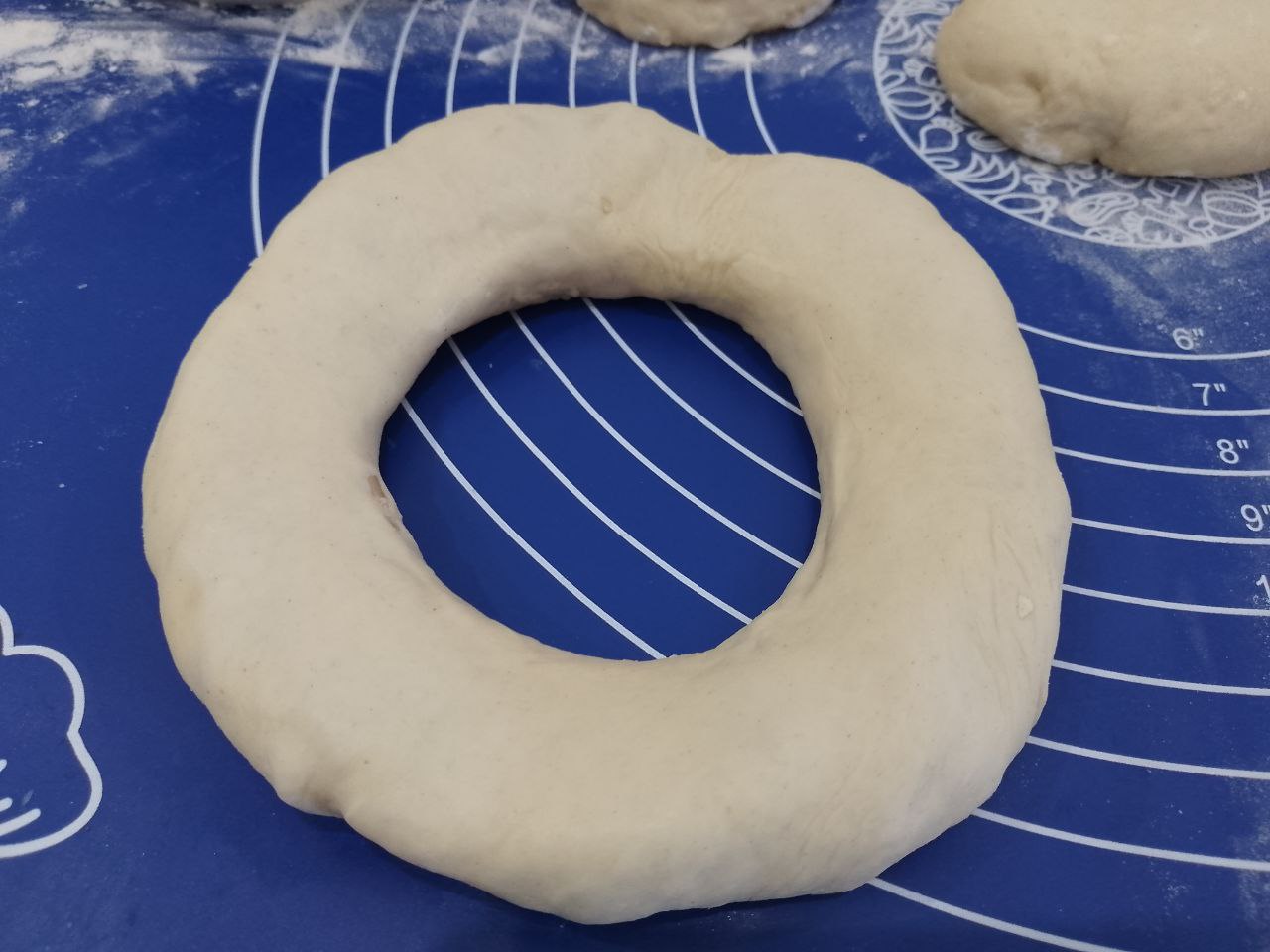 Бублики из дрожжевого теста с мясной начинкой, вкусные и сытные: Середину круга продавливаем и закрываем полностью начинку, формуем бублик.