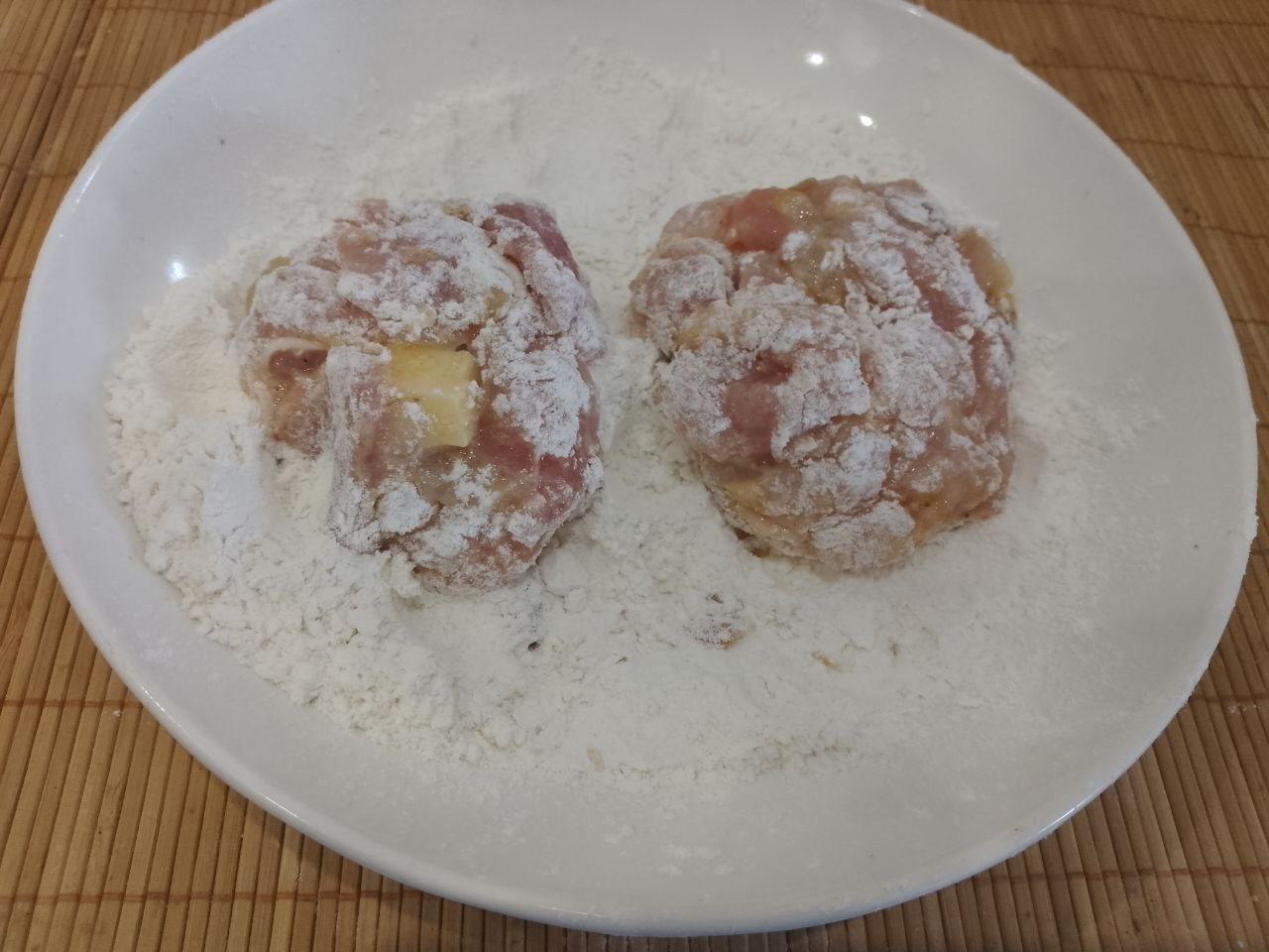 Котлеты из рубленого куриного мяса, сыра, запеченные в духовке: В тарелку насыпаем муку, формируем котлеты и обваливаем в муке.