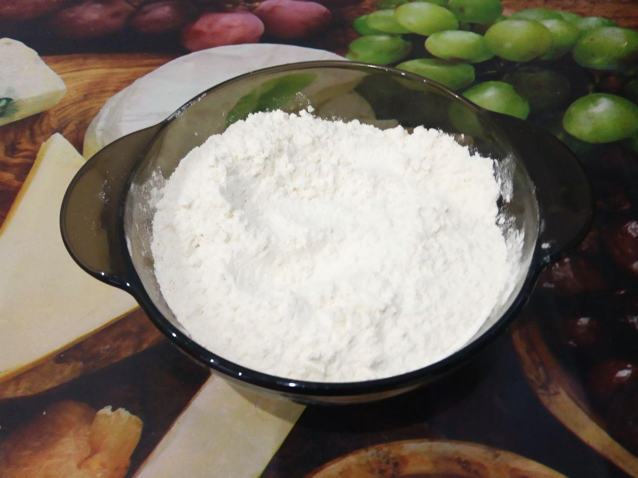 Вкусное шоколадное печенье с трещинками: Муку просеиваем через мелкое сито и высыпаем в смесь. Размешиваем сначала лопаткой, затем замешиваем мягкое и