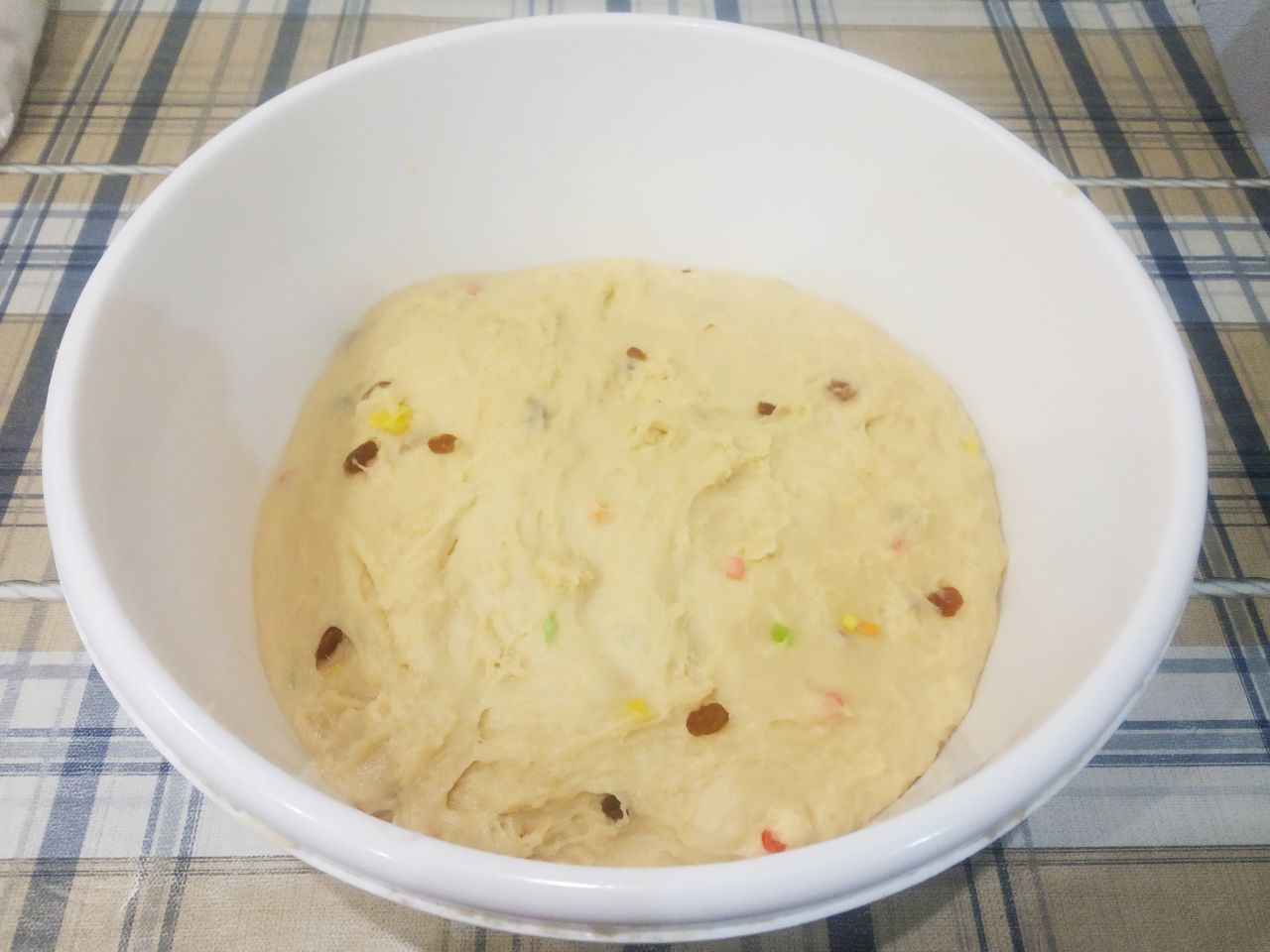 Домашние воздушные праздничные куличи: Когда тесто вымешено, кладем в тесто изюм посыпанный мукой и цукаты. Тесто вымешиваем пока изюм с цукатами