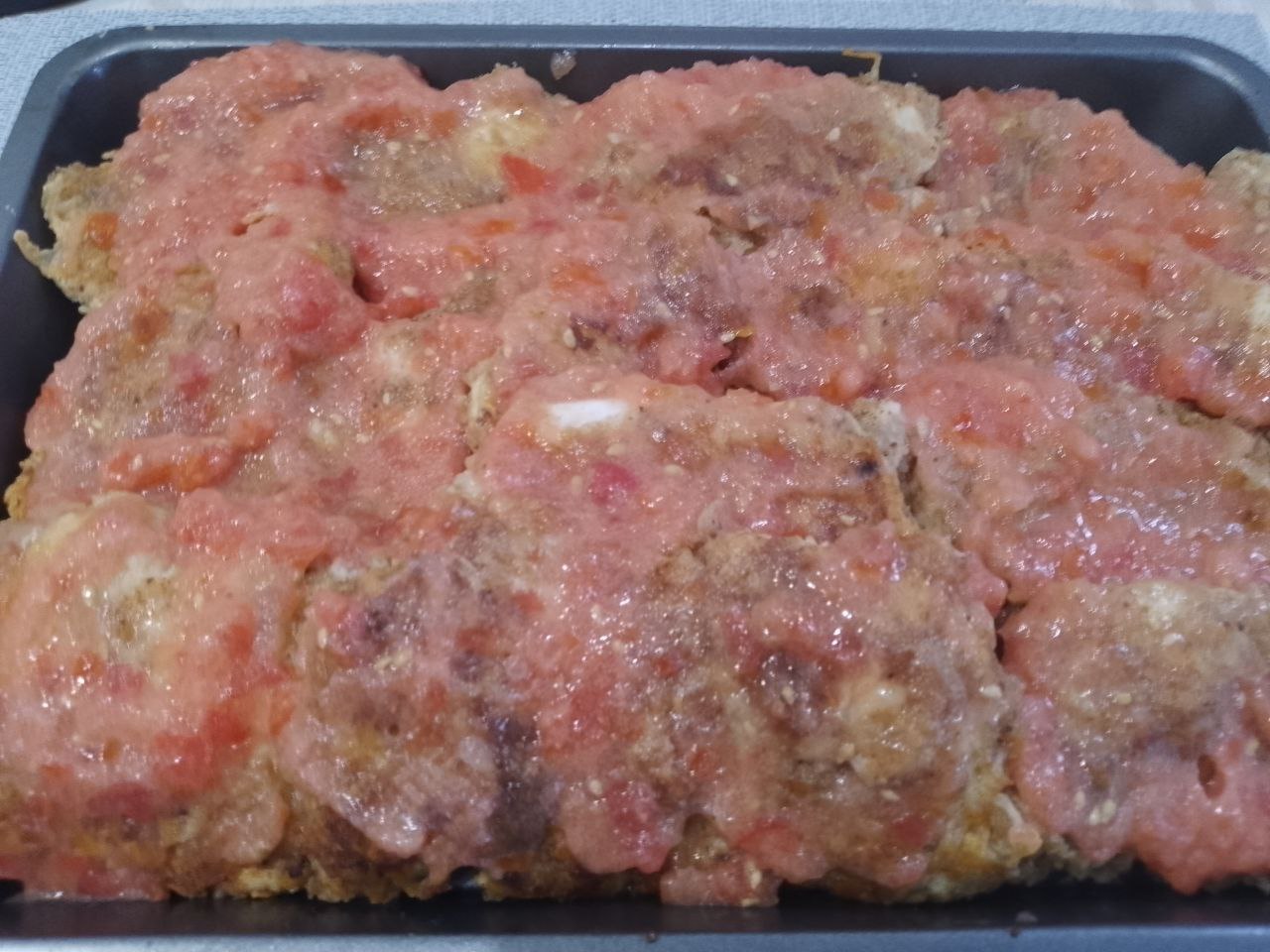 Курица пармиджано с протертыми помидорами и сыром: Заливаем мясо протертыми помидорами.
